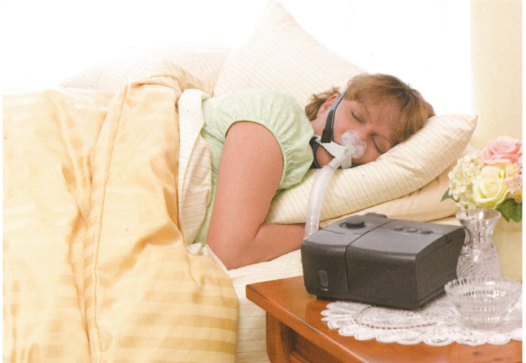 Woman sleeping with a CPAP mask